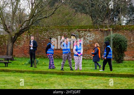 Christchurch, Dorset, UK. 1st March, 2022. Drizzle on pancakes! Flipping good fun had by all at Christchurch pancake race in Dorset on Shrove Tuesday on a drizzly morning - the miserable weather didn't deter those taking part and having fun. Credit: Carolyn Jenkins/Alamy Live News Stock Photo