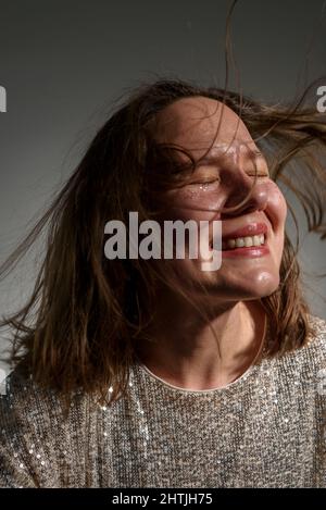 Happy smiling woman with sparkles on her face as freckles Stock Photo