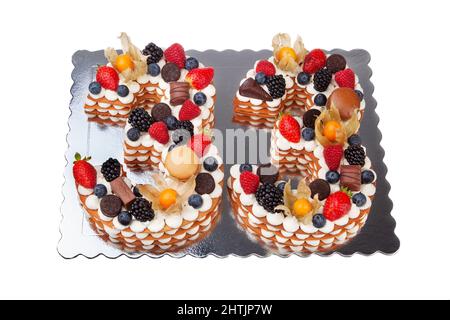 Creative birthday cake made of numbers thirty three from fruits and berries on a white background. Large background. Stock Photo