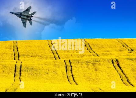 Collage of russian air fighter Mig-29 and Ukraine flag from Blue sky and yellow field. Stock Photo