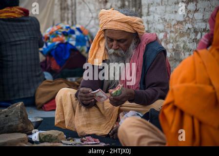 Kathmandu, Nepal. 01st Mar, 2022. A Sadhu seen counting money during the festival at premises of Pasupatinath Temple. Maha Shivaratri is one of the biggest Hindu festivals celebrated annually in honor of Lord Shiva and in particular, marks the night when Shiva performs the heavenly dance. Credit: SOPA Images Limited/Alamy Live News Stock Photo