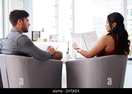 Coming up with the most innovative creative campaign. Shot of two young designers having a discussion in an office. Stock Photo