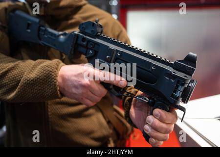 Nuremberg, Germany. 01st Mar, 2022. A man holds the 40mm x 46 caliber HK169 grenade launcher at the Heckler & Koch booth at the Enforce Tac trade show. The 'Enforce Tac' trade fair for security technology with more than 300 exhibitors will take place on March 1 and 2. Credit: Nicolas Armer/dpa/Alamy Live News Stock Photo