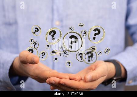 Hands with question marks floating Stock Photo