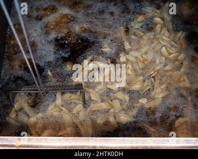 Freshly fried chips, at Compo's fish and chip restaurant and takeaway, Holmfirth, West Yorkshire. Stock Photo