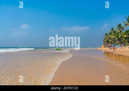 HIKKADUWA, SRI LANKA - JANUARY 22, 2022:Narigama beach at Hikkaduwa with surfer in the background Stock Photo