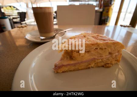 spanish tortilla or spanish omelette with ham and cheese with cafe leche leche coffee in a cafe Lanzarote, canary islands, spain Stock Photo