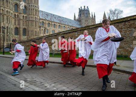 Picture dated February 28th shows Choristers from Ely Cathedral in Cambridgeshire having a practice runout for   Shrove Tuesday Pancake Race.   Choristers at Ely Cathedral in Cambridgeshire practised for their annual pancake race this morning (Mon).  The 10 boys and girls wore their red and white cassocks as they flipped pancakes outside the 12th century Cathedral. The youngsters laughed and giggled as they rehearsed for tomorrow’s traditional event and tried to improve their pancake tossing skills. Each year around 20 choristers race down the cathedral’s nave after Evensong. It is the third l Stock Photo