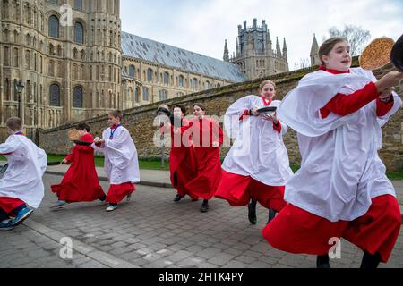 Picture dated February 28th shows Choristers from Ely Cathedral in Cambridgeshire having a practice runout for   Shrove Tuesday Pancake Race.   Choristers at Ely Cathedral in Cambridgeshire practised for their annual pancake race this morning (Mon).  The 10 boys and girls wore their red and white cassocks as they flipped pancakes outside the 12th century Cathedral. The youngsters laughed and giggled as they rehearsed for tomorrow’s traditional event and tried to improve their pancake tossing skills. Each year around 20 choristers race down the cathedral’s nave after Evensong. It is the third l Stock Photo