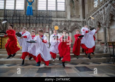 Picture dated February 28th shows Choristers from Ely Cathedral in Cambridgeshire having a practice runout for   Shrove Tuesday Pancake Race.   Choristers at Ely Cathedral in Cambridgeshire practised for their annual pancake race this morning (Mon).  The 10 boys and girls wore their red and white cassocks as they flipped pancakes outside the 12th century Cathedral. The youngsters laughed and giggled as they rehearsed for tomorrow’s traditional event and tried to improve their pancake tossing skills. Each year around 20 choristers race down the cathedral’s nave after Evensong. It is the third l Stock Photo