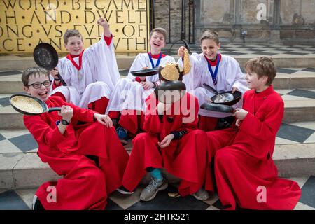 Picture dated February 28th shows Choristers from Ely Cathedral in Cambridgeshire having a practice runout for   Shrove Tuesday Pancake Race.   Choristers at Ely Cathedral in Cambridgeshire practised for their annual pancake race this morning (Mon).  The 10 boys and girls wore their red and white cassocks as they flipped pancakes outside the 12th century Cathedral. The youngsters laughed and giggled as they rehearsed for tomorrow’s traditional event and tried to improve their pancake tossing skills. Each year around 20 choristers race down the cathedral’s nave after Evensong. It is the third l Stock Photo