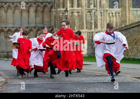 Picture dated February 28th shows Choristers from Ely Cathedral in Cambridgeshire having a practice runout for   Shrove Tuesday Pancake Race.   Choristers at Ely Cathedral in Cambridgeshire practised for their annual pancake race this morning (Mon).  The 10 boys and girls wore their red and white cassocks as they flipped pancakes outside the 12th century Cathedral. The youngsters laughed and giggled as they rehearsed for tomorrow’s traditional event and tried to improve their pancake tossing skills. Each year around 20 choristers race down the cathedral’s nave after Evensong. It is the third l Stock Photo