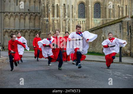 Picture dated February 28th shows Choristers from Ely Cathedral in Cambridgeshire having a practice runout for   Shrove Tuesday Pancake Race.   Choristers at Ely Cathedral in Cambridgeshire practised for their annual pancake race this morning (Mon).  The 10 boys and girls wore their red and white cassocks as they flipped pancakes outside the 12th century Cathedral. The youngsters laughed and giggled as they rehearsed for tomorrow’s traditional event and tried to improve their pancake tossing skills. Each year around 20 choristers race down the cathedral’s nave after Evensong. It is the third l Stock Photo