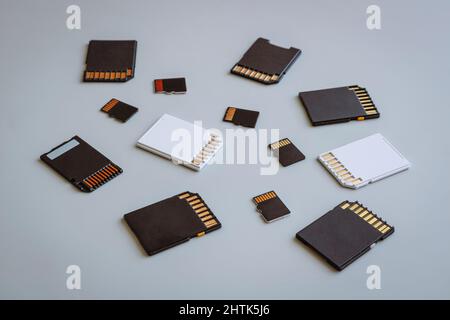 SD and MicroSD memory cards on a neutral gray background. Stock Photo