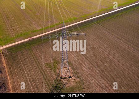 Aerial view of power lines on a power pole in a field in winter Stock Photo