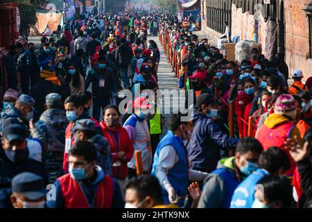 Nepalese Hindu devotees line up to enter the Pashupati Temple to perform rituals to Lord Shiva during the Mahashivaratri festival.Hindu Devotees from Nepal and India come to this temple to take part in the Shivaratri festival which is one of the biggest Hindu festivals dedicated to Lord Shiva and celebrated by devotees all over the world. Stock Photo