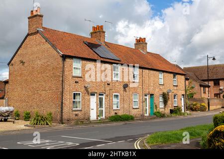 Woodbridge Suffolk UK May 24 2021: A row of 3 traditional English town houses. One home has installed solar panels to save on their energy bills in th Stock Photo