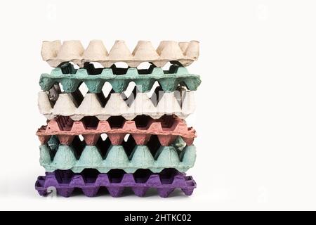 A heap of empty colored cardboard egg tray on a white background Stock Photo