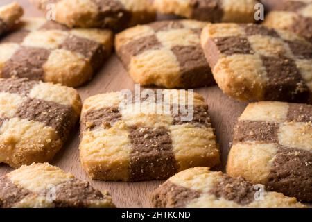 chequered biscuits, closeup view of cookies, square shape snack taken in shallow depth of field Stock Photo