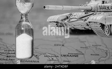 black and white geographic map of europe and ukraine, hourglass and a tank in foreground Stock Photo