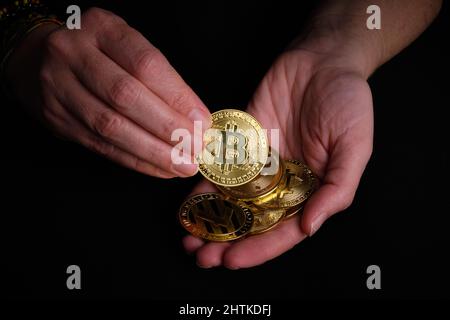 Woman with some bitcoins in his hands Stock Photo