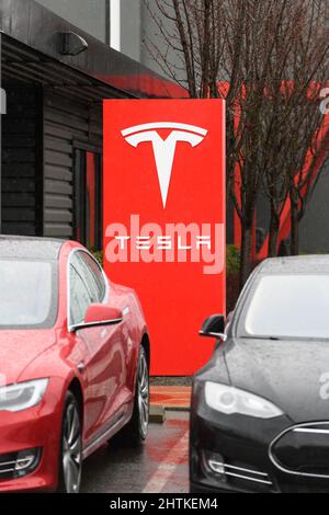 Seattle - February 28, 2022; Sign at the Tesla showroom and service center in Seattle on a rainy day Stock Photo