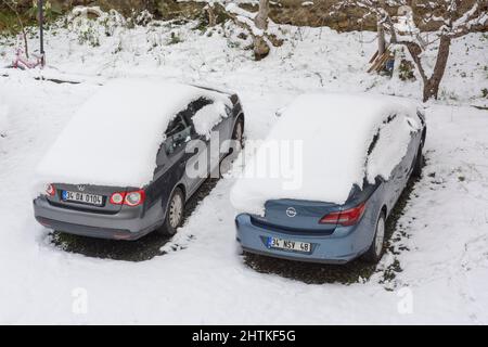 ISTANBUL - TURKEY - JANUARY 30 2022: Parking on the street covered with snow. Car drowned in snow, abnormal amount of snowfall in winter. Stock Photo