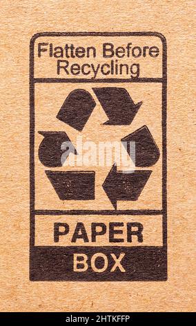Cardboard Box with Black Recycle Symbol Background. Stock Photo