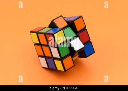 ISTANBUL - TURKEY - JANUARY 30 2022: Rubik's cube on the orange background. Rubik's Cube invented by a Hungarian architect Erno Rubik in 1974. Stock Photo
