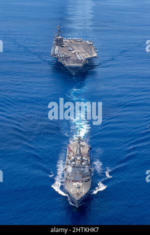 Indian Ocean, United States. 17 December, 2021. The U.S. Navy Arleigh Burke-class guided-missile destroyer USS Stockdale leads the Nimitz-class aircraft carrier USS Carl Vinson during a bilateral training exercise with the Royal Australian Air Force, December 17, 2021 in the Indian Ocean.  Credit: MCS Tyler R. Fraser/Planetpix/Alamy Live News Stock Photo