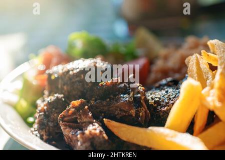 Traditional Greek Beef Stifado with rice and french fries. Stock Photo