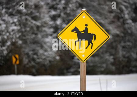 Yellow Caution Horse Riding Sign in a Rural Setting in Winter Stock Photo