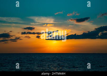 sunset background. Sunset over the sea with clouds. Landscape of the sea. Stock Photo