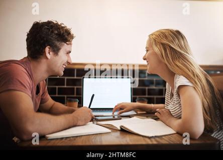 Im feeling confident about these exams. Cropped shot of two happy young students having a study session at their favourite cafe. Stock Photo