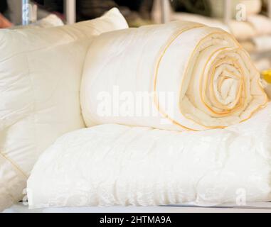 Rolled up blankets and pillows on shelf close-up Stock Photo
