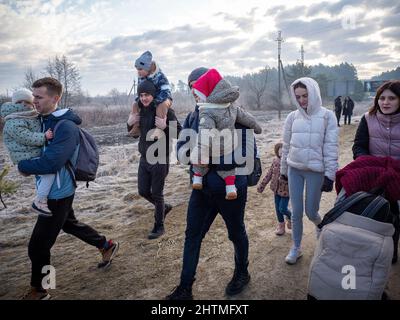 Yavoriv, Ukraine. 26th Feb, 2022. Refugees seen having to give up their mode of transportation and walk to the Polish border on foot as the wait for vehicles to cross the border is estimated to take days.At dawn of 24 February 2022, Russia launched a full-scale invasion to Ukraine. Civilian homes and hospitals have been destroyed by the Russian military action which caused many people to become homeless. Credit: SOPA Images Limited/Alamy Live News Stock Photo