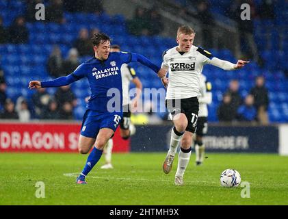 Derby County's Louie Sibley (right) and Cardiff City's Ryan Wintle battle for the ball during the Sky Bet Championship match at the Cardiff City Stadium, Cardiff. Picture date: Tuesday March 1, 2022. Stock Photo