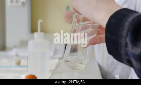 Two young female scientist doing experiments in lab. Women doing experiments in the laboratory, surrounded by professional equipment. Stock Photo