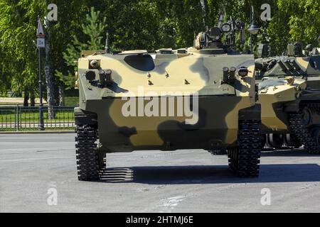 Russian military vehicles on the city square. Russian infantry fighting vehicle BMP and armored personnel carrier BTR. Stock Photo