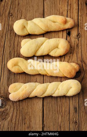 Homemade cheese twisted cookies on old wooden table vertical Stock Photo