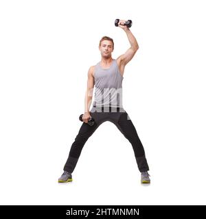 Toning his arms. A fit young man working out with dumbbells while isolated on a white background. Stock Photo