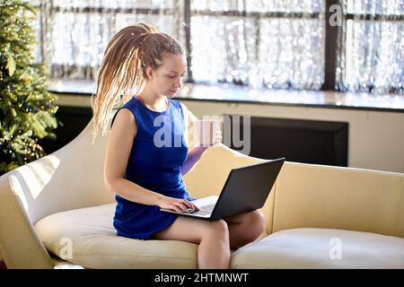 Home office for woman who works online using laptop. Stock Photo