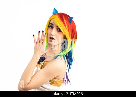Young woman with rainbow hair turns and looks shocked into the camera medium studio shot white background. High quality photo Stock Photo