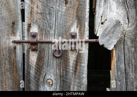 sliding lock on old barn door Stock Photo