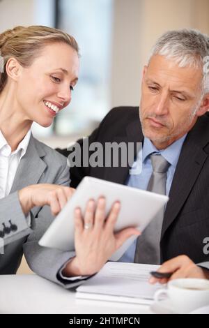 Sharing expertise. Businesswoman showing her colleague some information. Stock Photo
