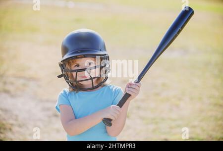 Little child baseball player focused ready to bat. Kid holding a baseball bat. Stock Photo