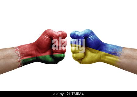 Two hands punch to each others on white background. Country flags painted fists, conflict crisis concept between belarus and ukraine Stock Photo