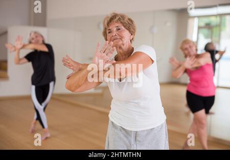 Portrait of an elderly dancing woman practicing vigorous swing Stock Photo