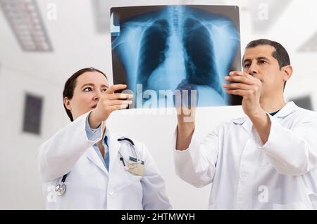 Shot of two doctors discussing the results of an X-ray at hospital Stock Photo