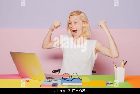 Excited amazed teacher works on laptop. Shcool teacher in class. Professional emotional portrait. Stock Photo